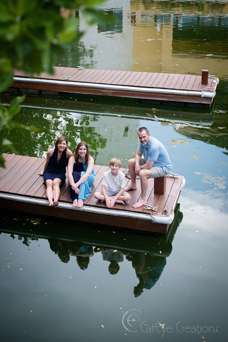 Family sitting on a dock