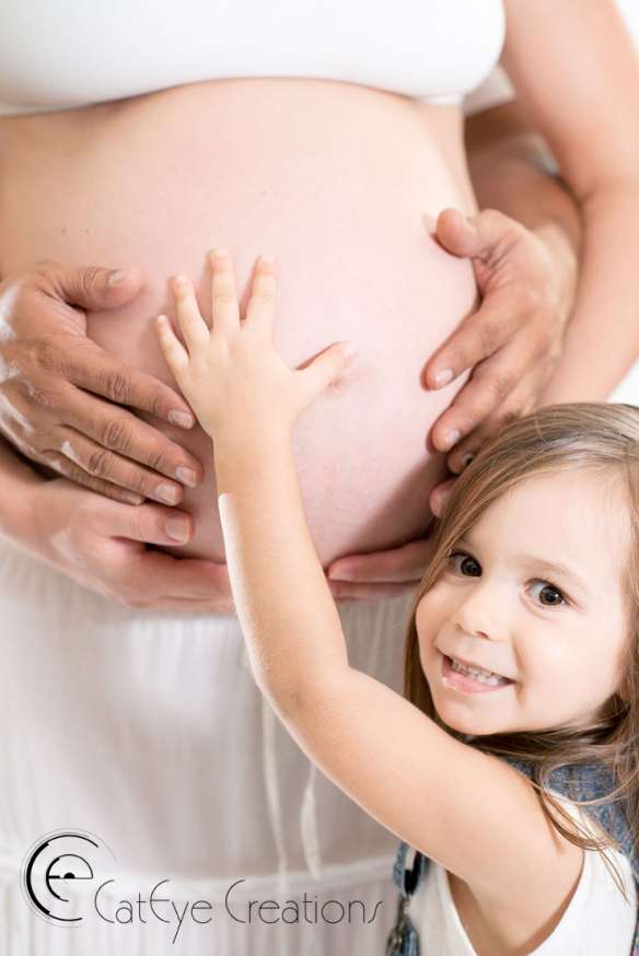 pregnancy photography little girl touching moms belly