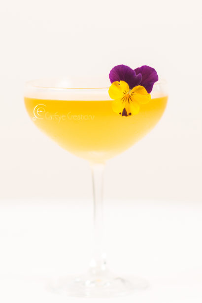 mixology photography at grand hyatt pansy flower drink