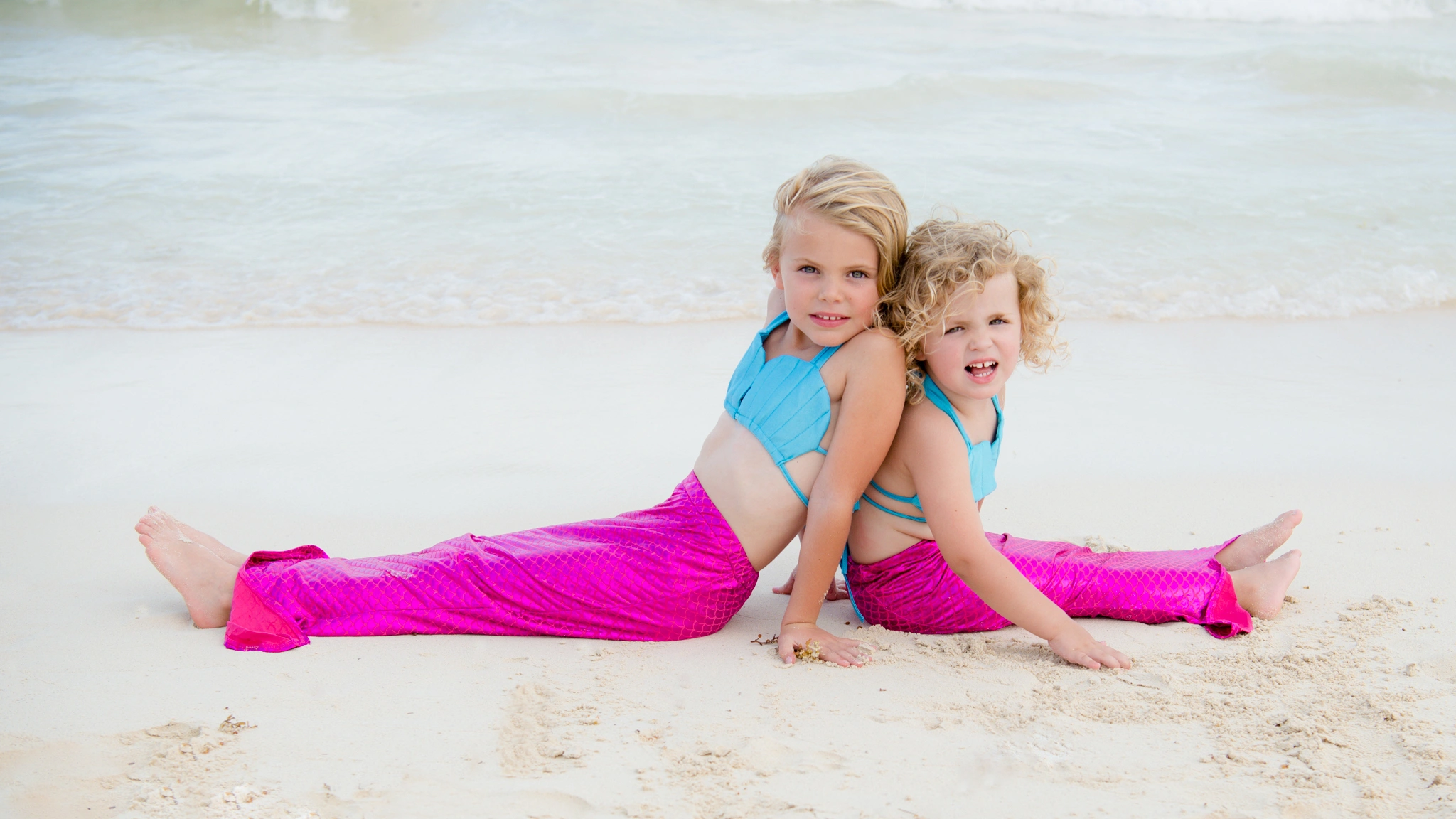 two little girls in mermaid outfits